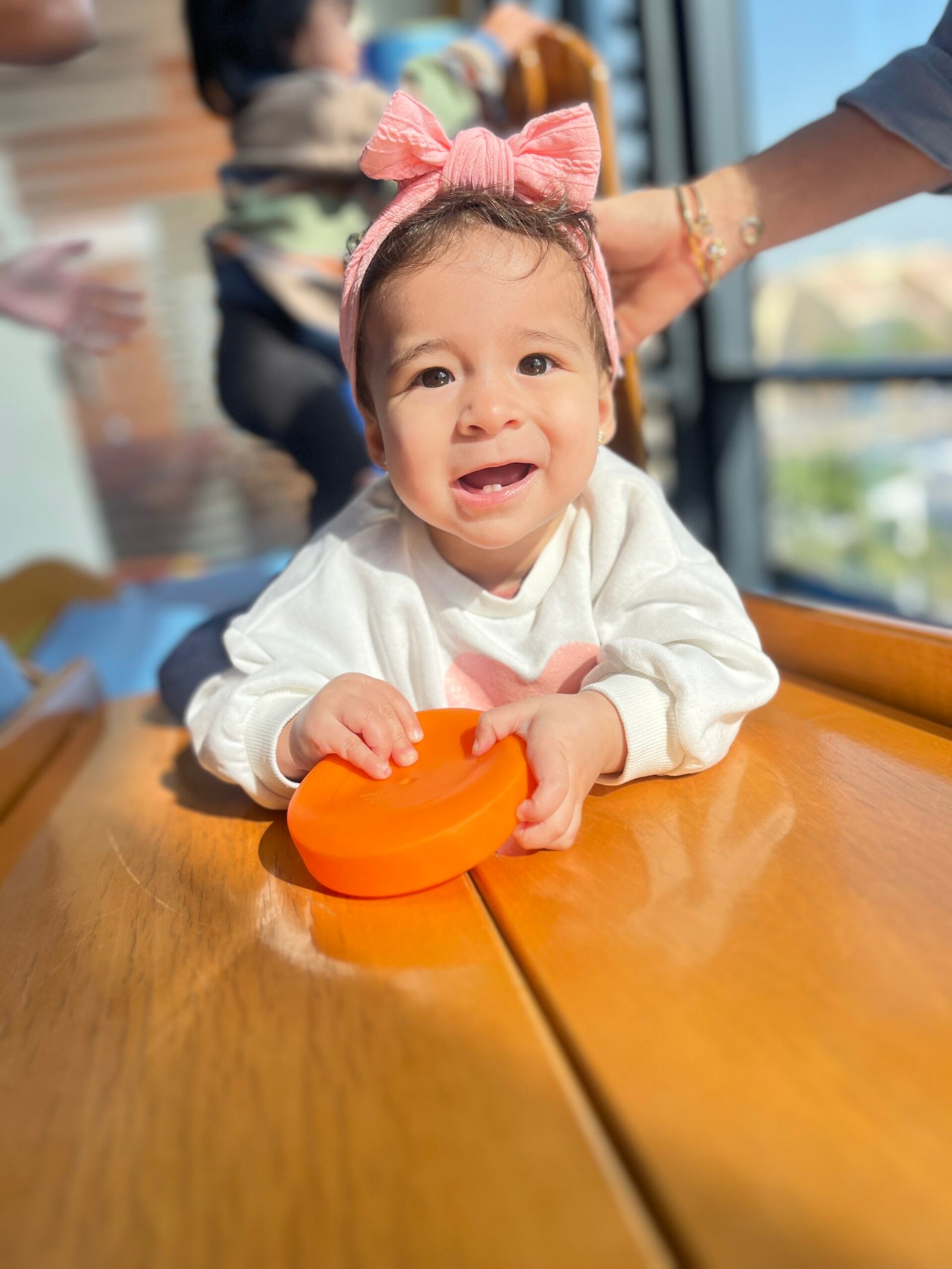 A smiling baby enjoying Gymboree ball play