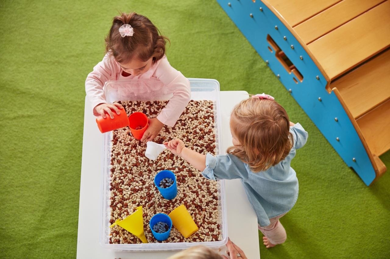 Toddlers taking part in a sensory play activity